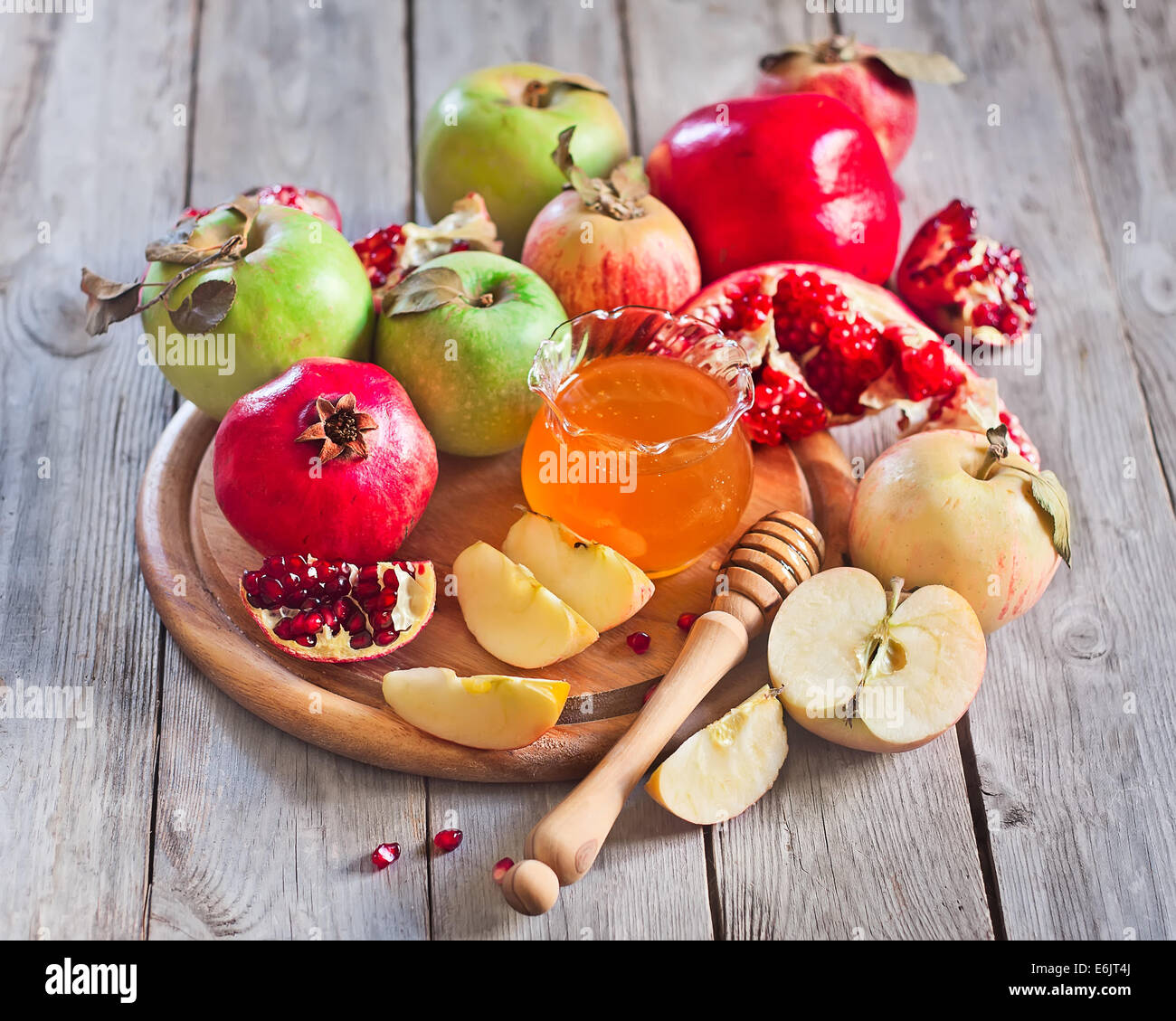 Pomegranate, apple and honey, traditional food of jewish New Year celebration, Rosh Hashana. Selective focus. Stock Photo