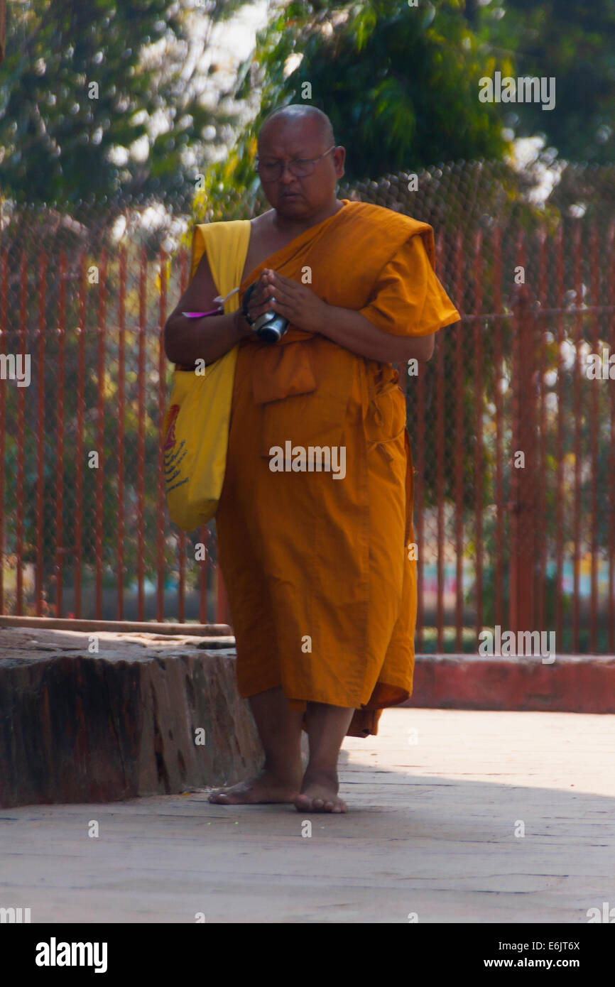 Buddhist monk in orange robe circles the Dhamekh Stupa. Stock Photo
