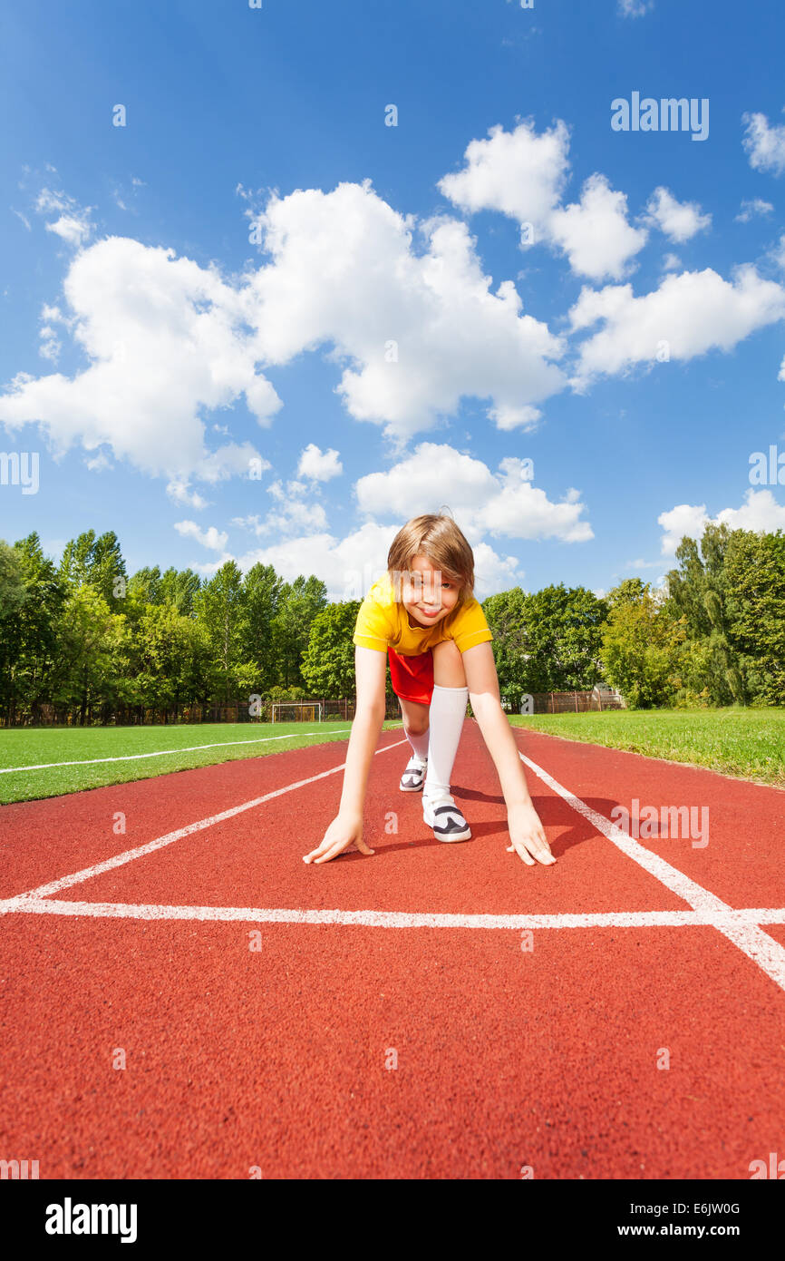 Boy ready to run with two straight arms on ground Stock Photo