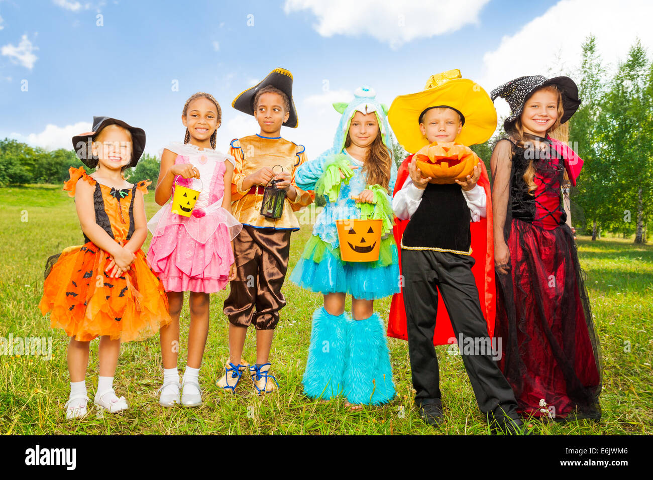 Happy children in colorful Halloween costumes Stock Photo - Alamy