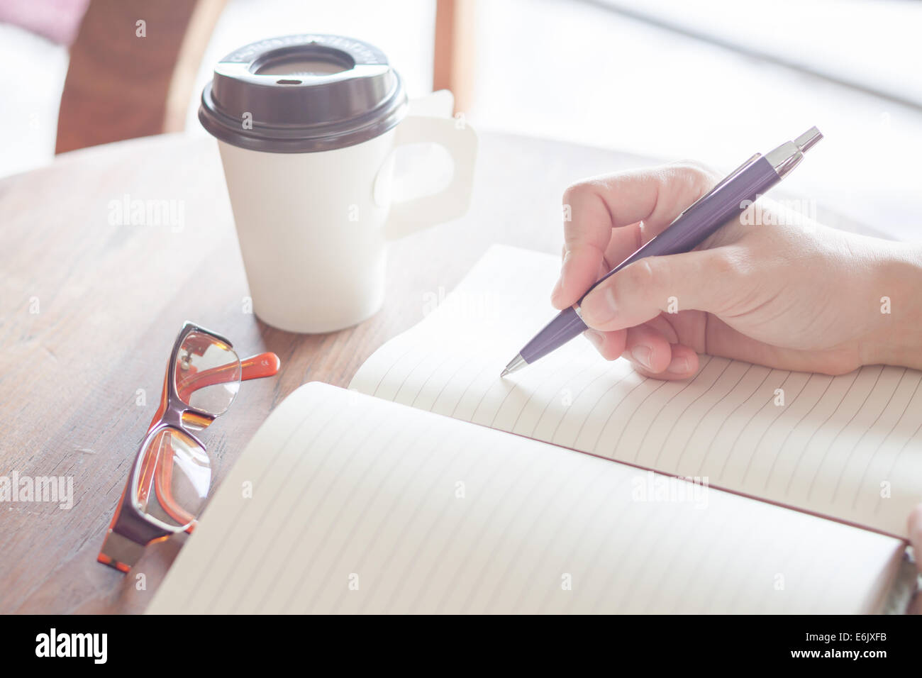 Woman writing on notebook, stock photo Stock Photo