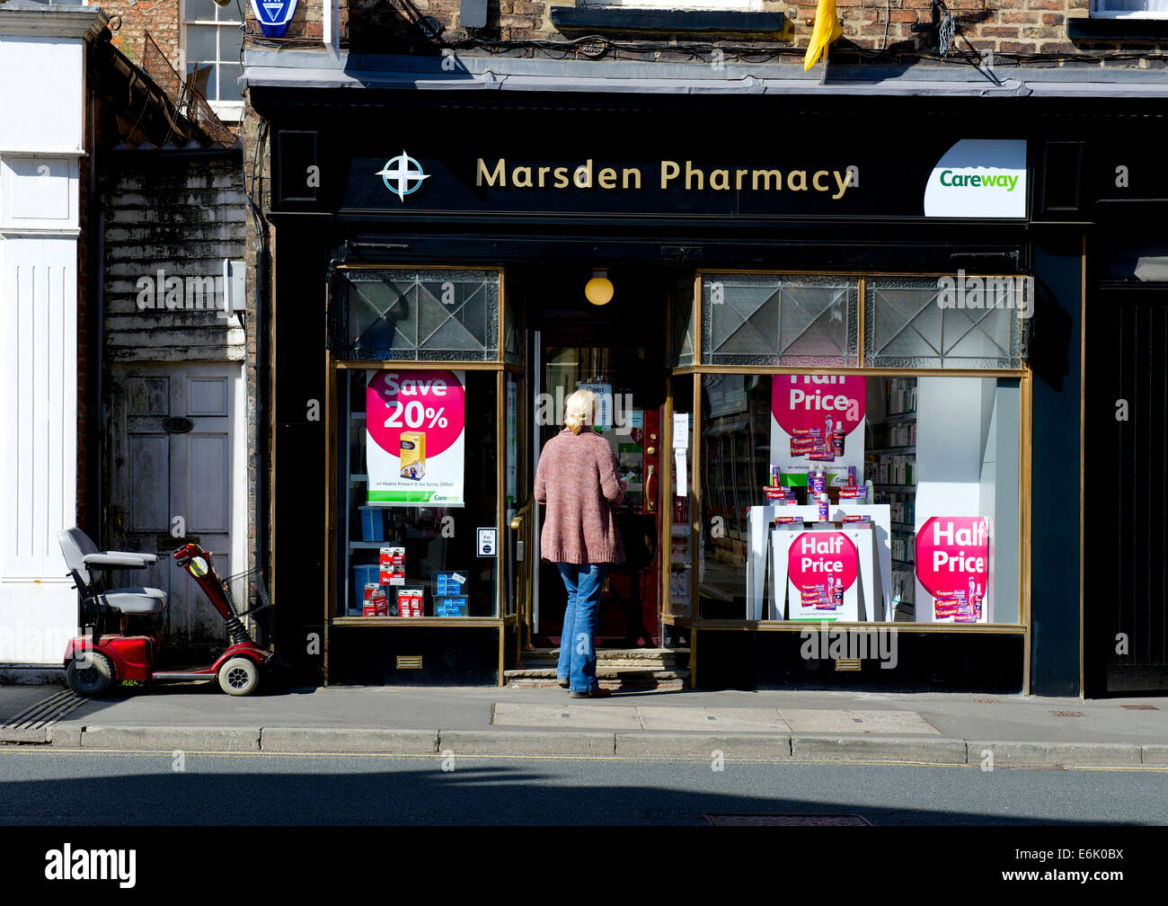 Woman walking into Marsden Pharmacy, Ripon, North Yorkshire, England UK Stock Photo Alamy