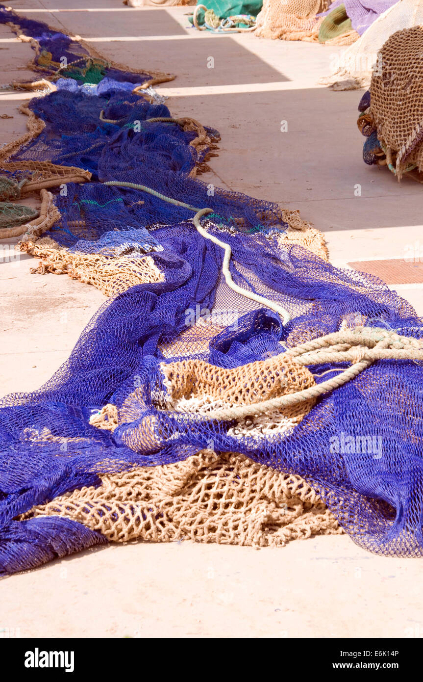 A blue fishing net extended in the port Stock Photo
