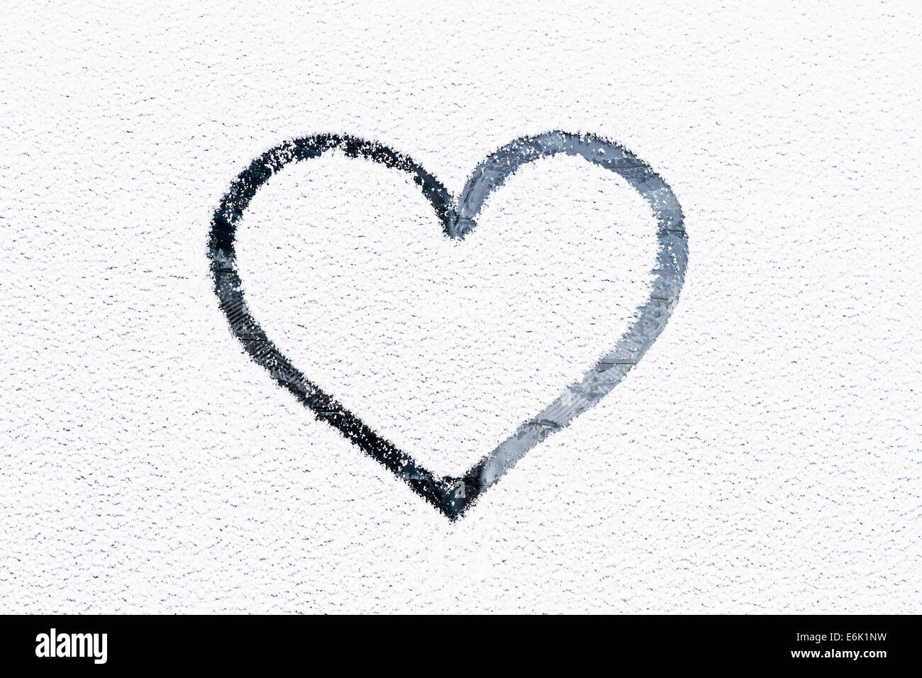 Heart drawn on frosty window. Stock Photo