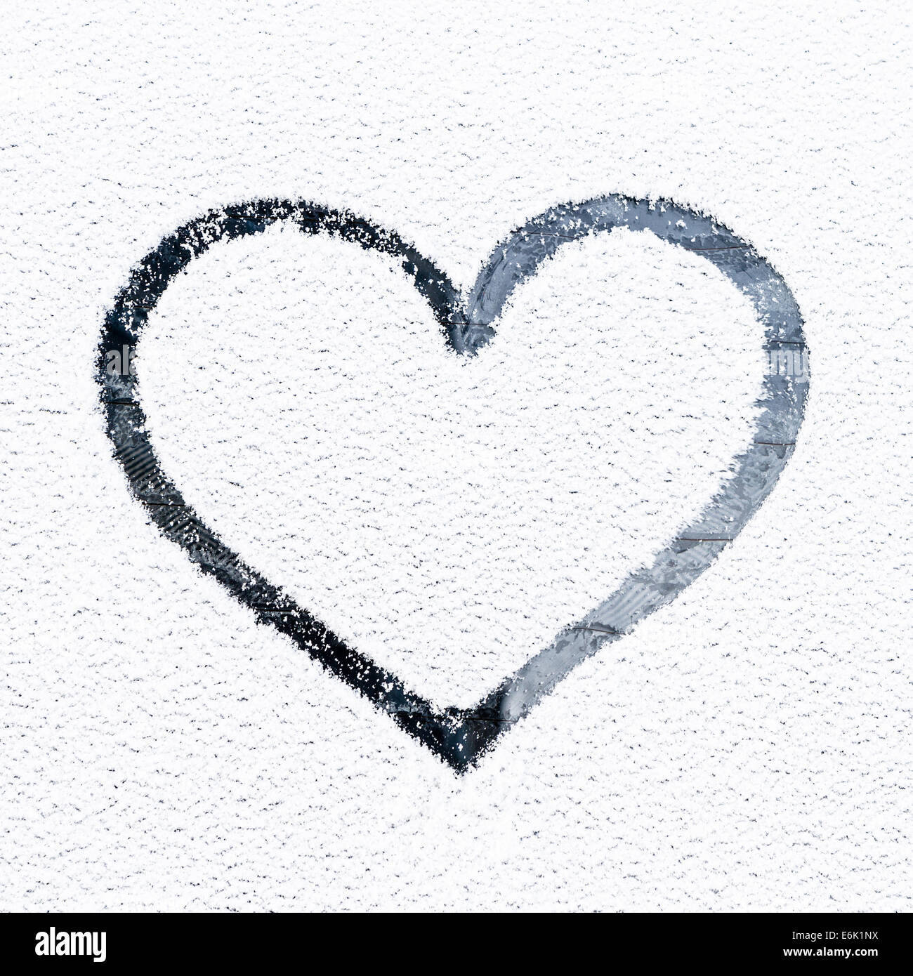 Heart drawn on frosty window. Stock Photo