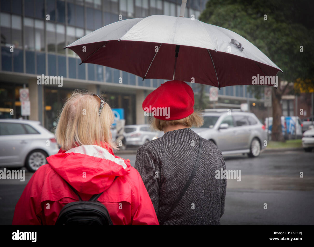 Pedestrians with umbrella Stock Photo