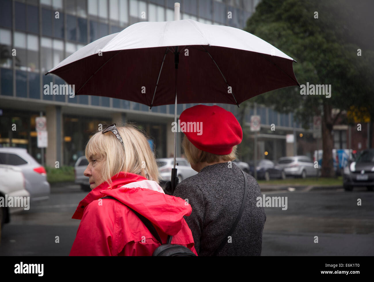 Pedestrians with umbrella Stock Photo
