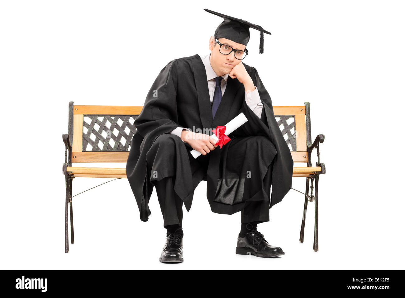 Angry college graduate holding a diploma isolated on white background ...
