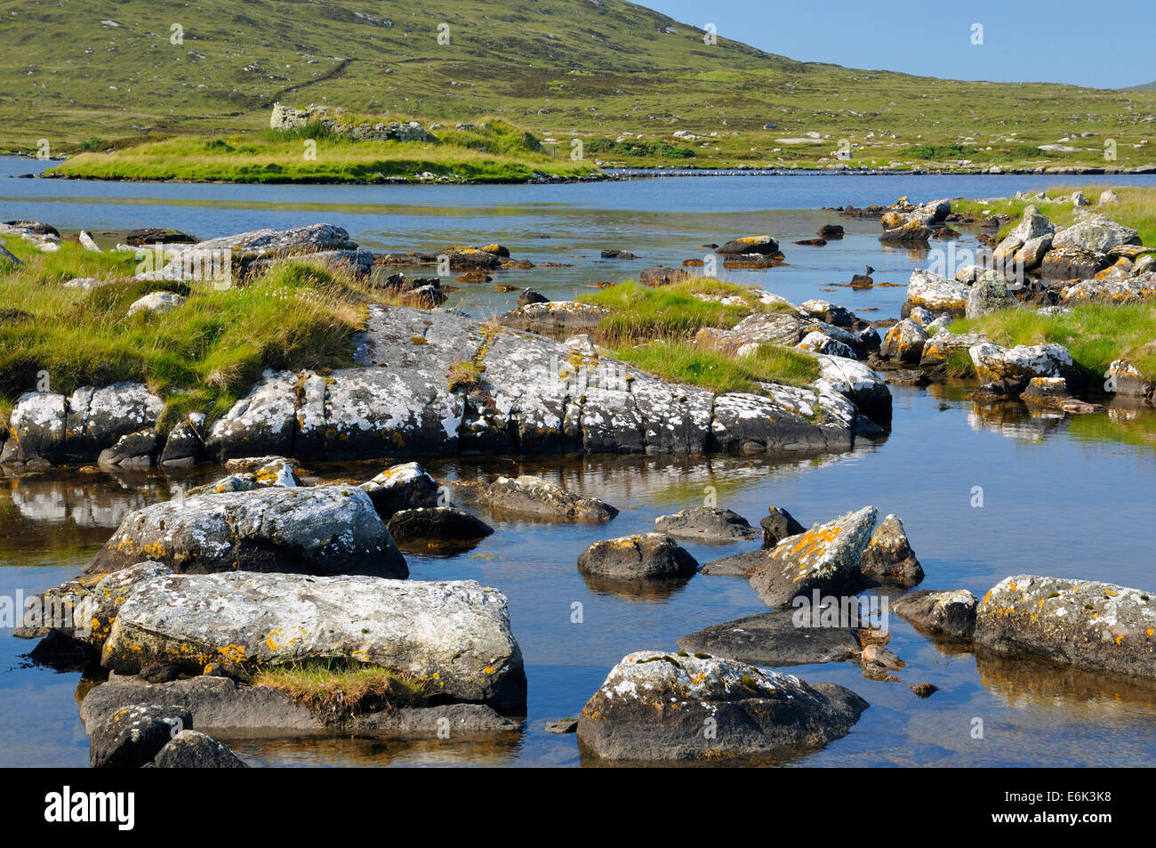 Loch an Sticer with Dun an Sticer Circular fort 1000BC, Port nan Long, Newtonferry, North Uist, Outer Hebrides Stock Photo