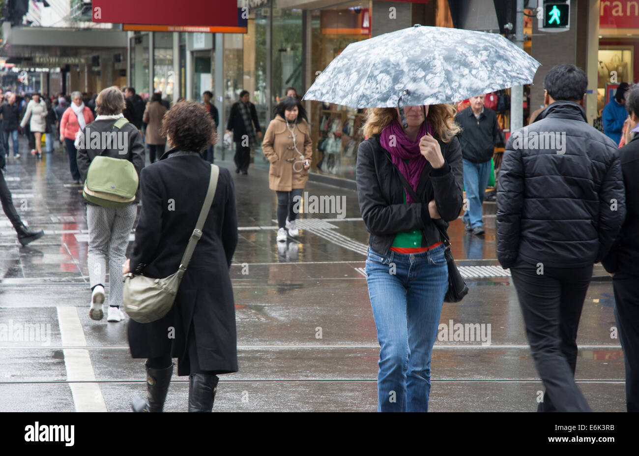 Pedestrians with umbrella Stock Photo