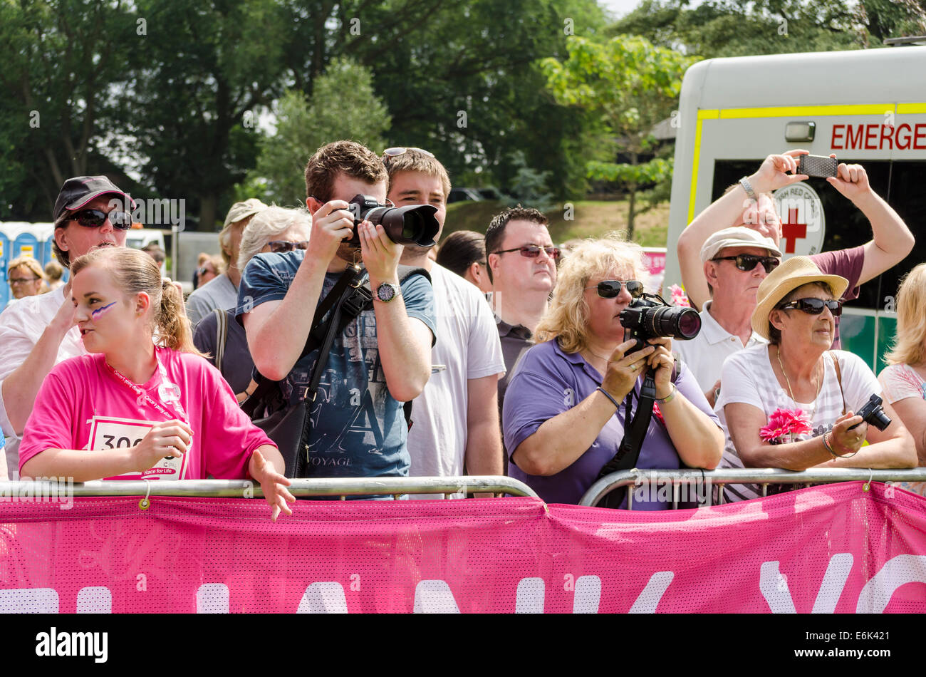 People taking photos at a Race for Life event UK 2014 Stock Photo