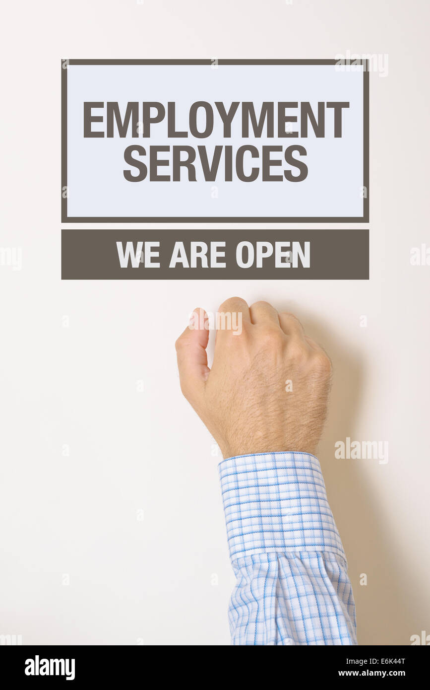 Businessman knocking on employment services door looking for a help or advice Stock Photo