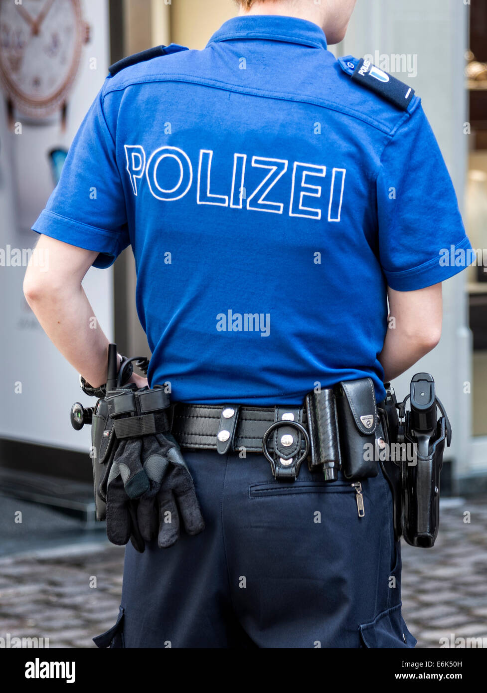 Female Swiss police officer in uniform with equipment, from behind,  Lucerne, Switzerland Stock Photo - Alamy