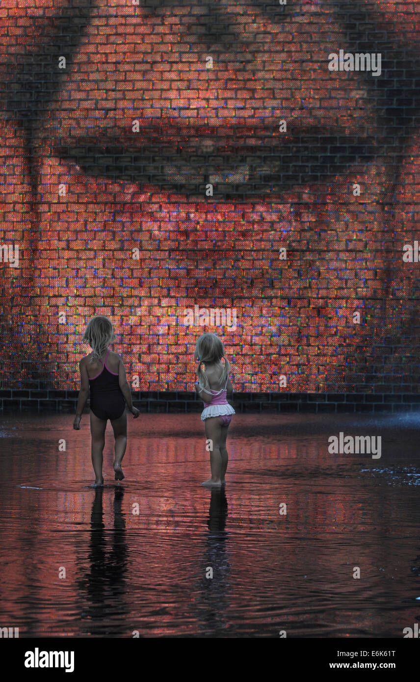 Two girls standing in front of the Crown Fountain, Millennium Park, Chicago, Illinois, United States Stock Photo