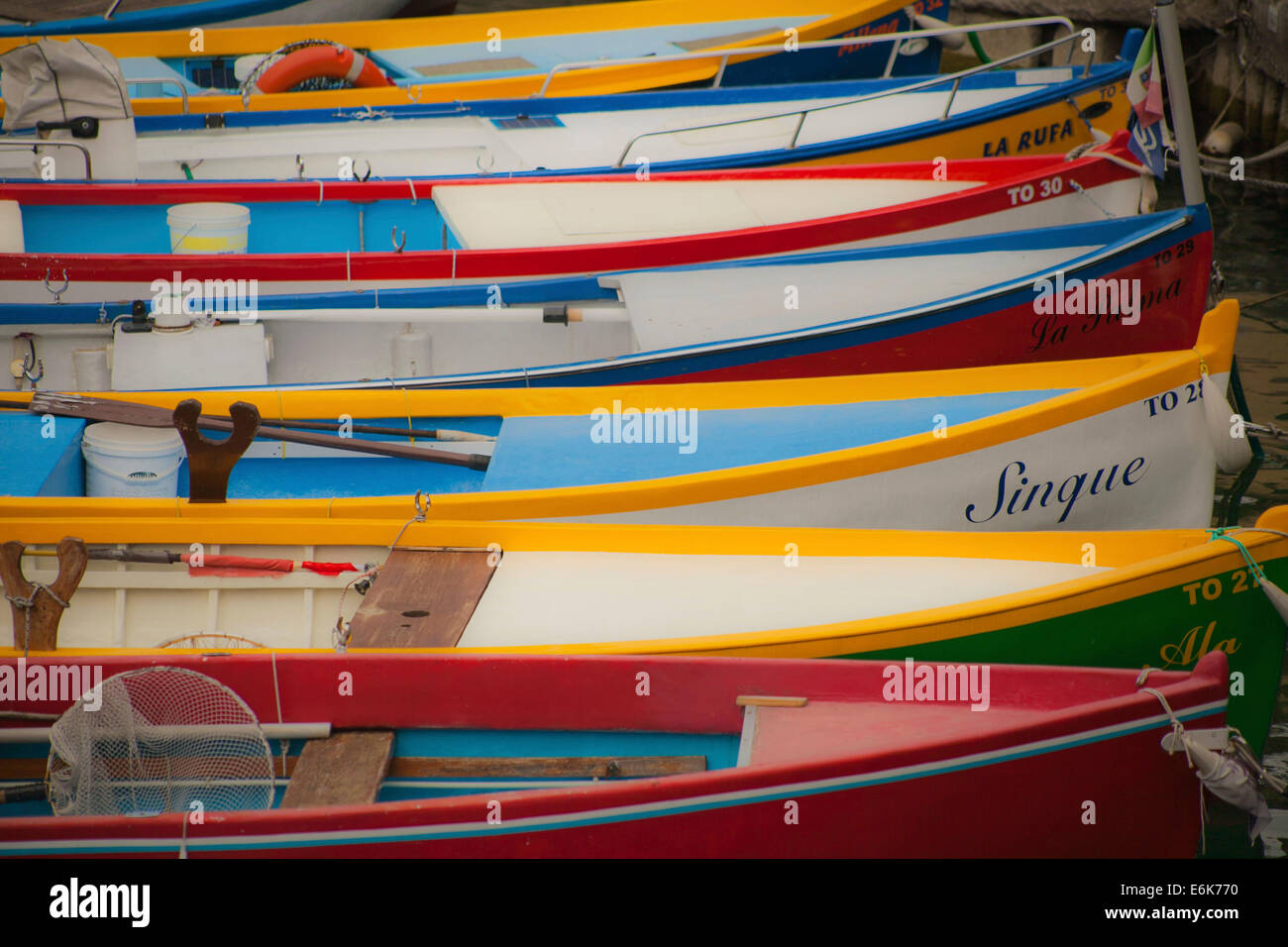 Colourful fishing boats in a small harbour of Lake Garda, Torri del Benaco, Italy Stock Photo