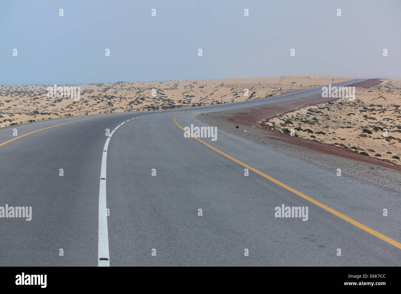 Omani highway through the sand desert, Ad Dakhiliyah, Oman Stock Photo