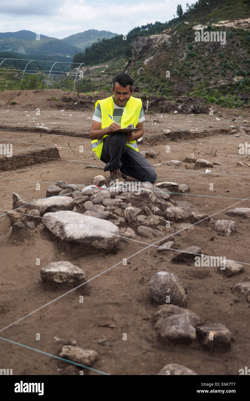 Archaeologist examining archaeological dig site Stock Photo