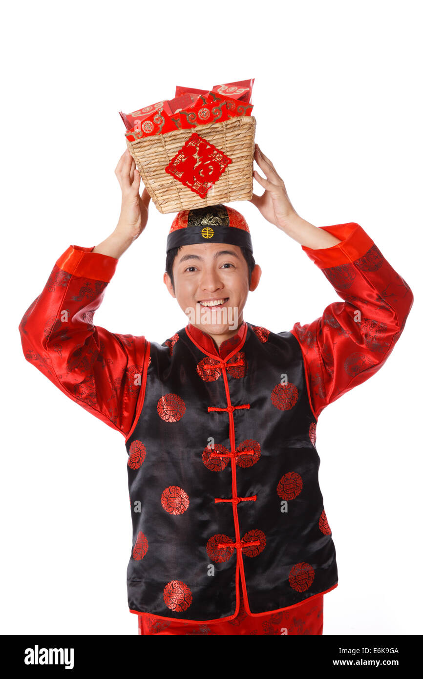 Young man in Chinese traditional clothes with red envelopes celebrating Chinese New Year Stock Photo