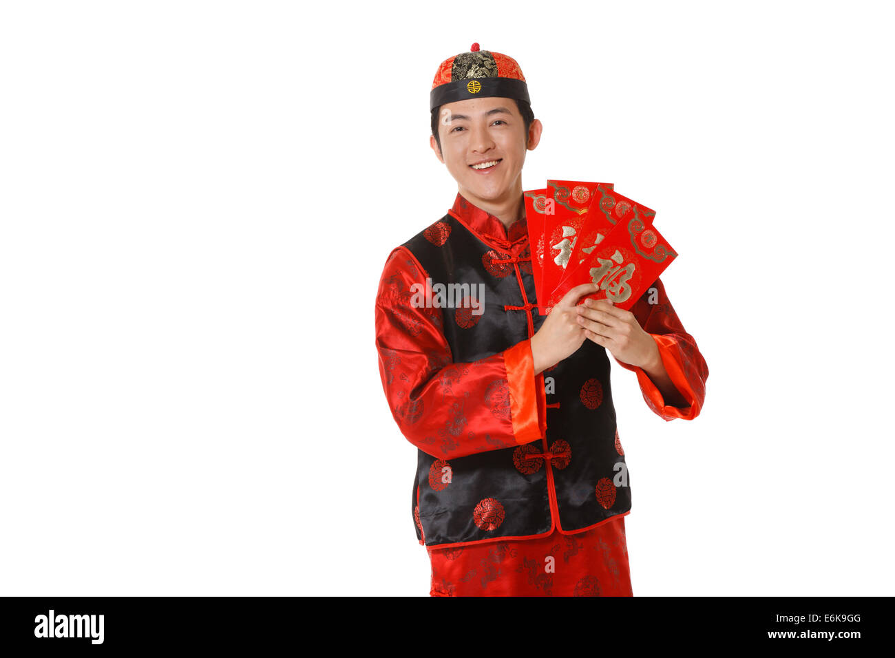 Young man in Chinese traditional clothes with red envelopes celebrating Chinese New Year Stock Photo