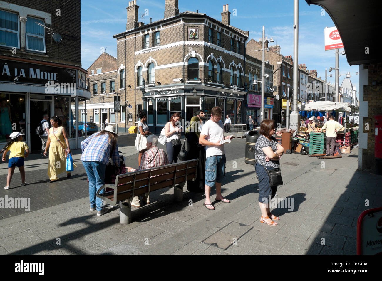 People standing in line queuing  for ATM cashpoint Walthamstow High Street in London UK  KATHY  DEWITT Stock Photo