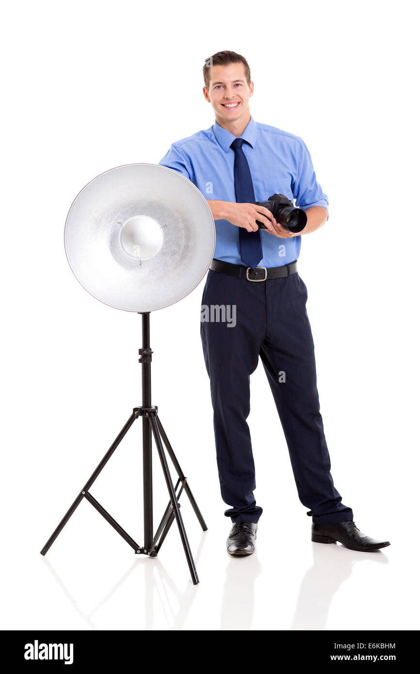 happy male photographer in studio standing next to beauty dish Stock Photo