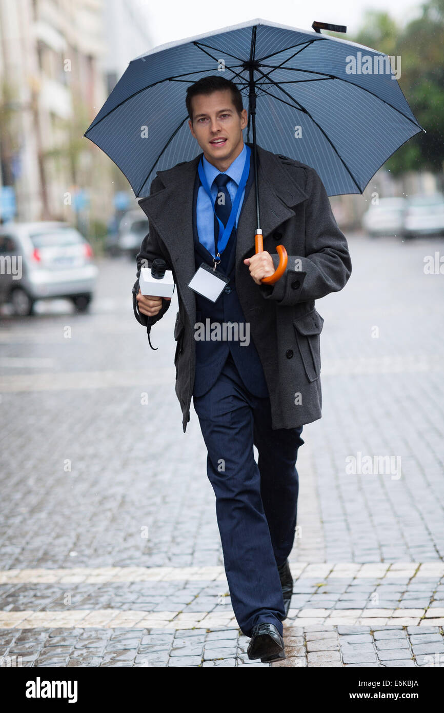 young journalist rushing in urban city for breaking news Stock Photo