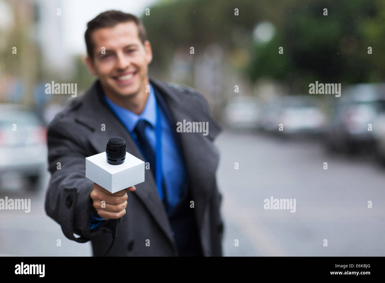 close up portrait of young journalist giving microphone Stock Photo