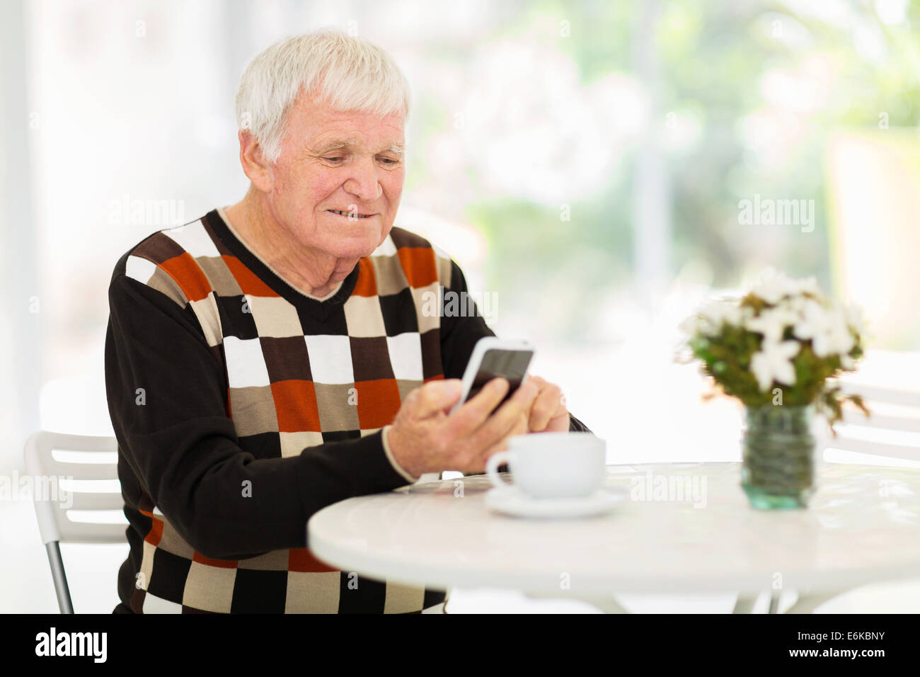 happy senior man using smart phone at home Stock Photo
