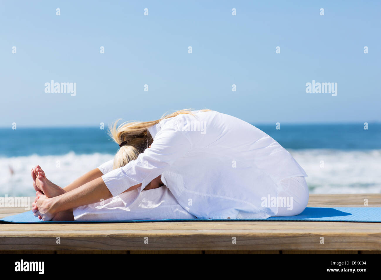 healthy mid age woman stretching outdoors Stock Photo