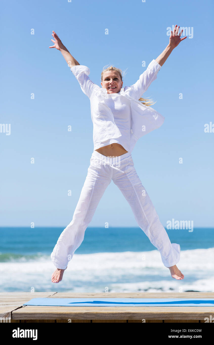 Beautiful mature woman jumping hi-res stock photography and images - Alamy