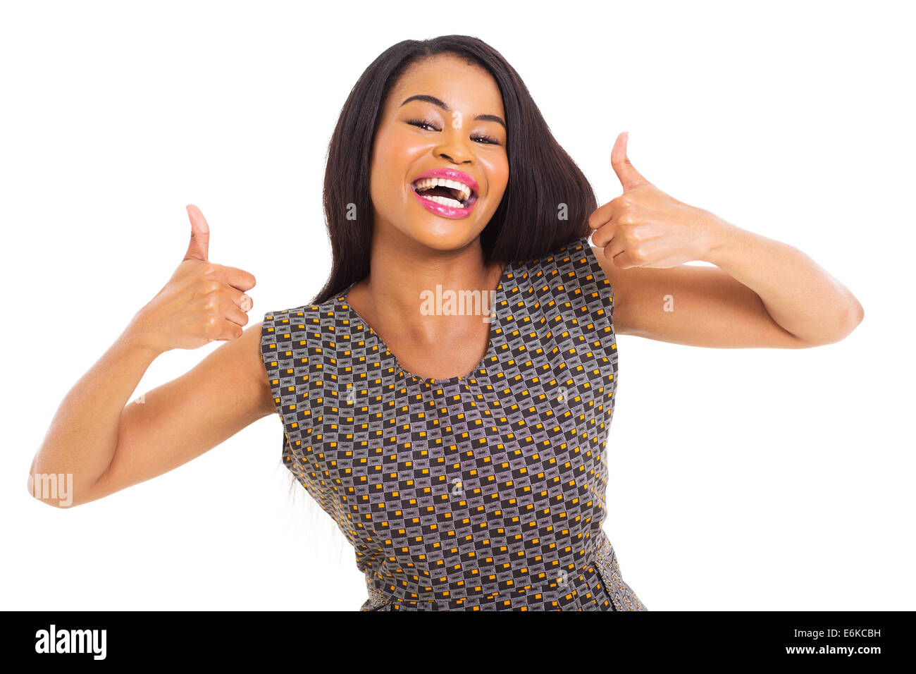 portrait of cheerful African American woman giving thumbs up on white ...