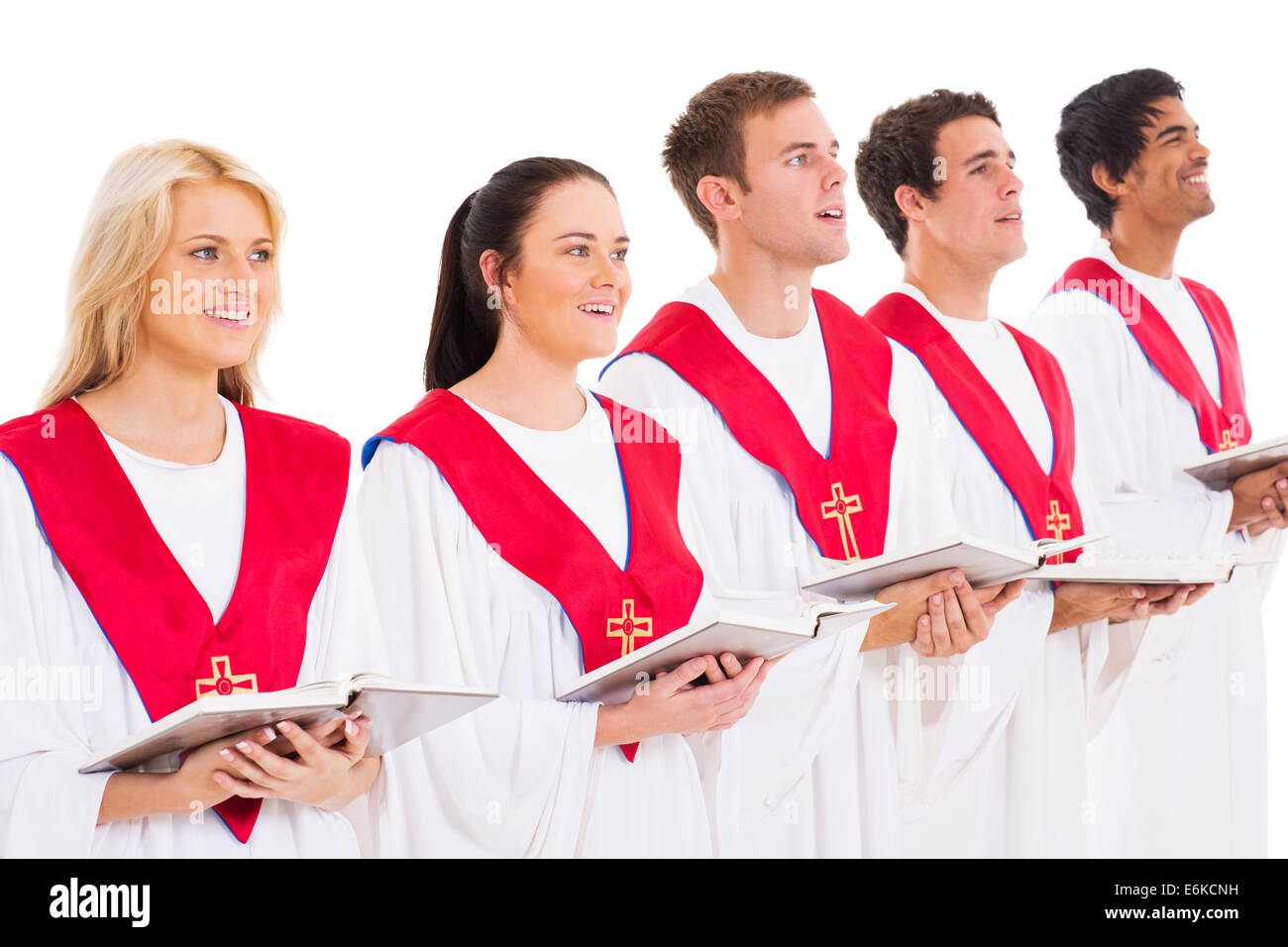 church choir members holding hymn books and singing Stock Photo