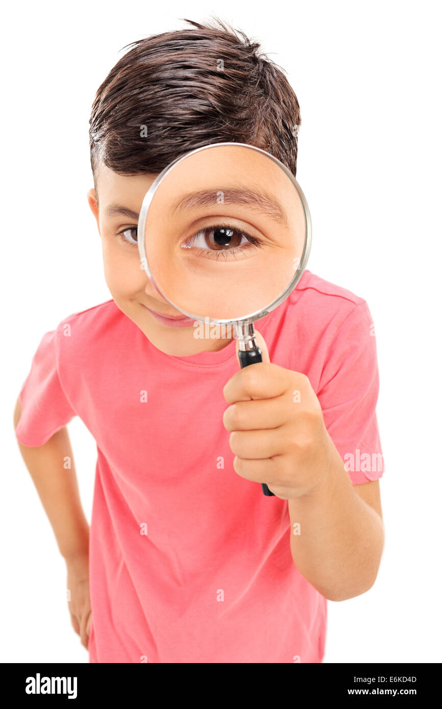 Little boy looking through a magnifying glass isolated on white background Stock Photo