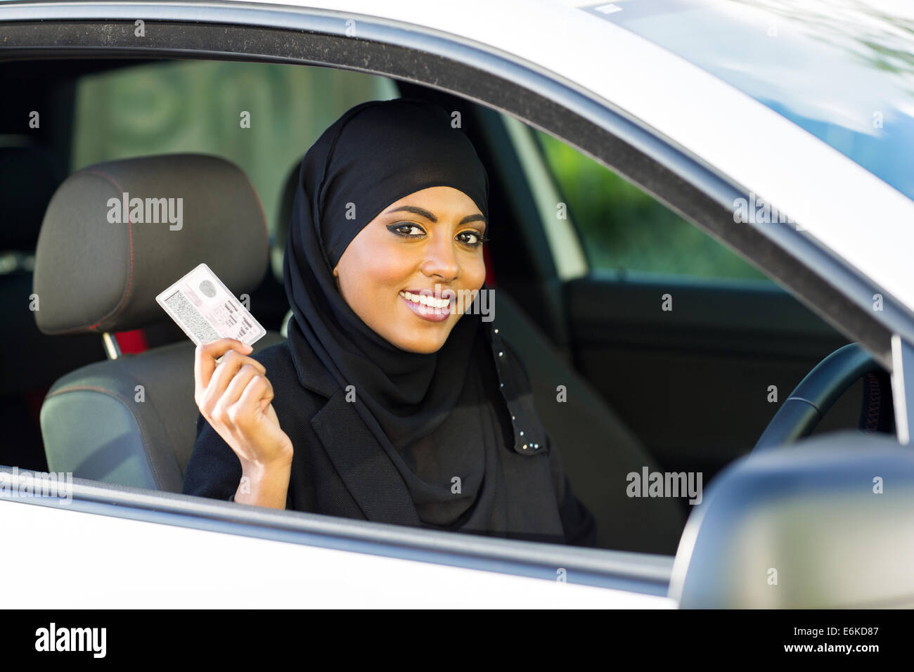 cheerful Muslim woman showing a driving license she just got Stock Photo