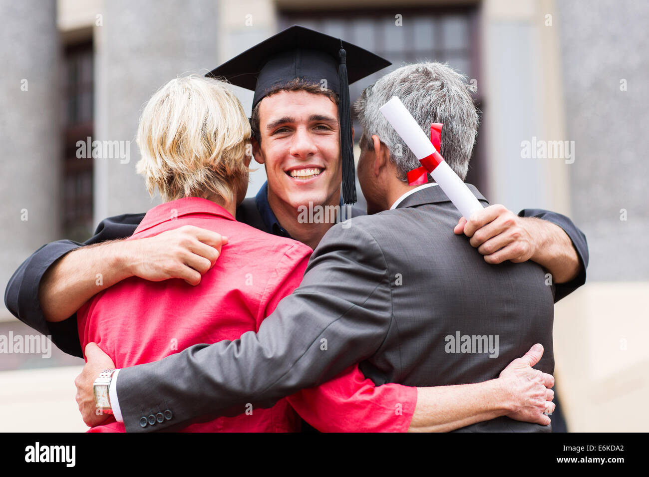 handsome young male graduate hugging his parents at graduation Stock ...