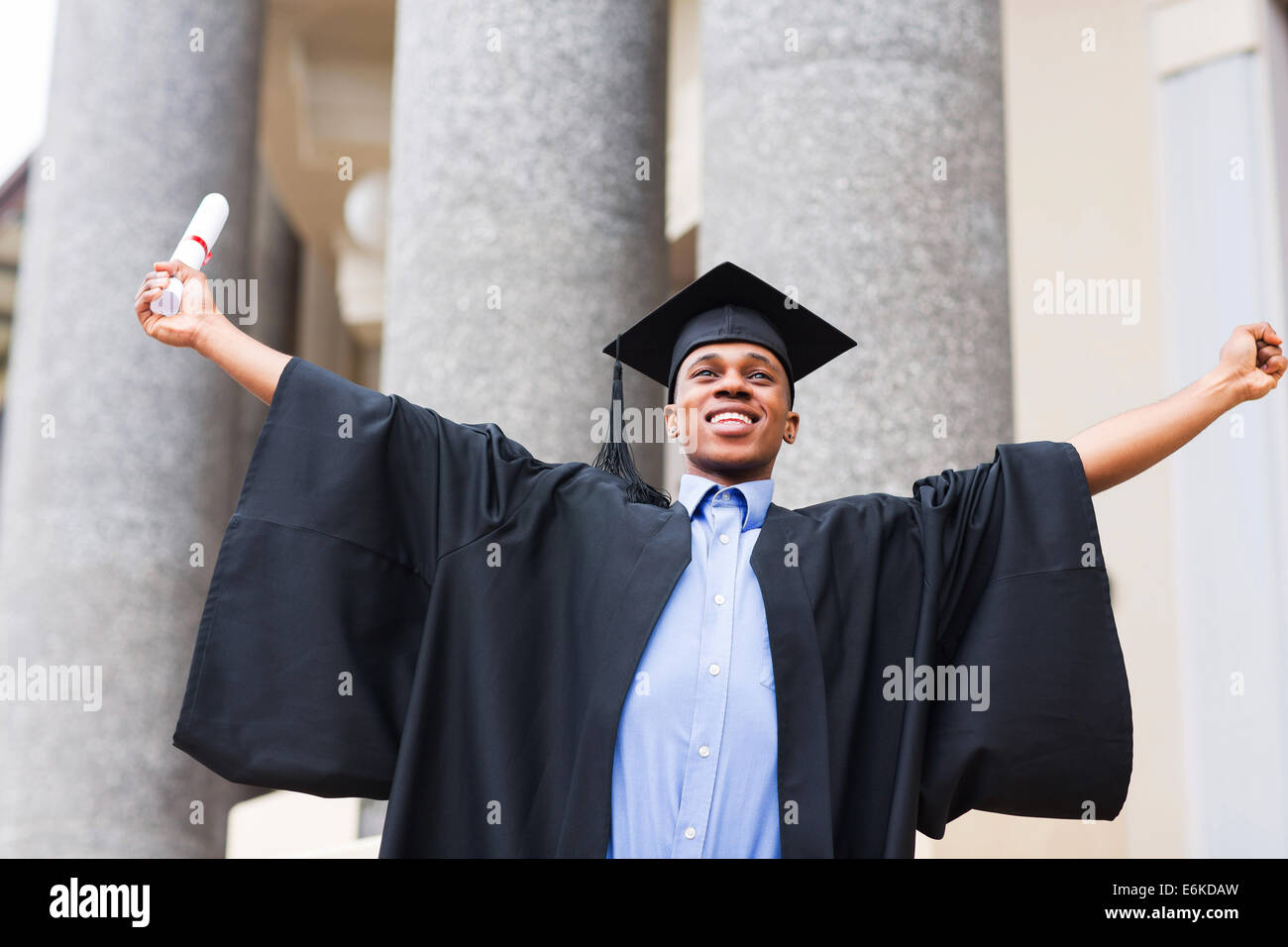 cheerful African male graduate holding his diploma Stock Photo - Alamy
