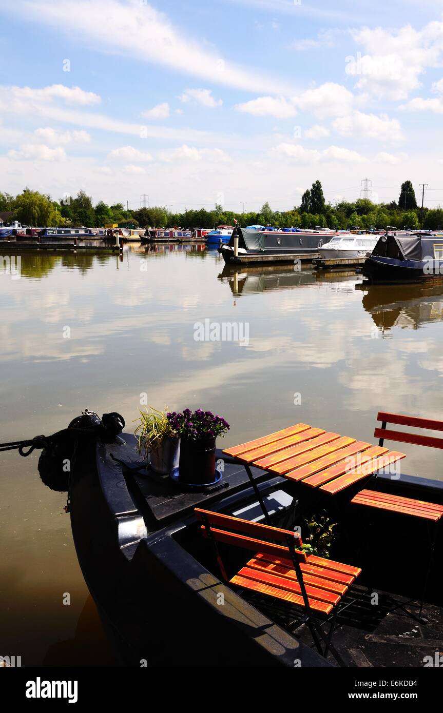 Small table with two chairs on a narrowboat in the canal basin, Barton
