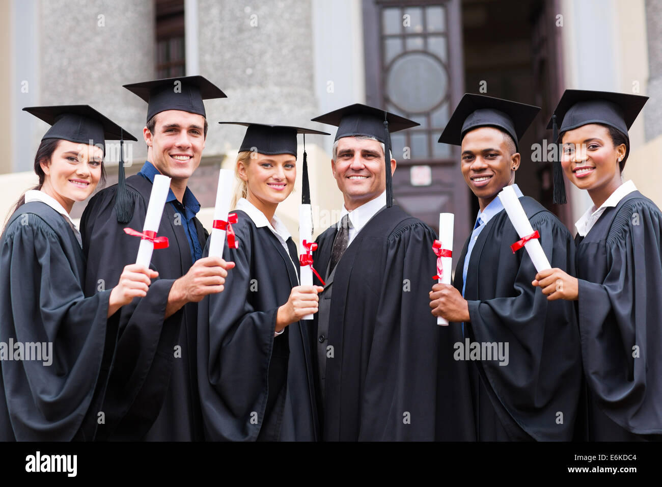 closeup behind a female college graduate wearing a black fringe gown and a  black hat, Concept of Successful Education in Hight School,Congratulated  Degree Stock Photo
