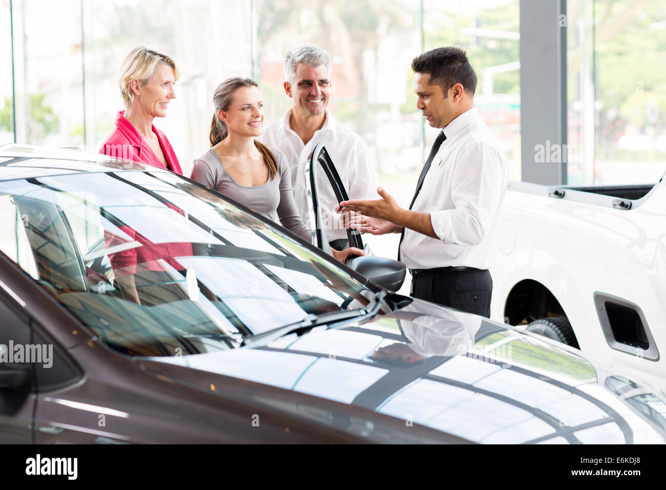 vehicle salesman showing new car to a family Stock Photo Alamy