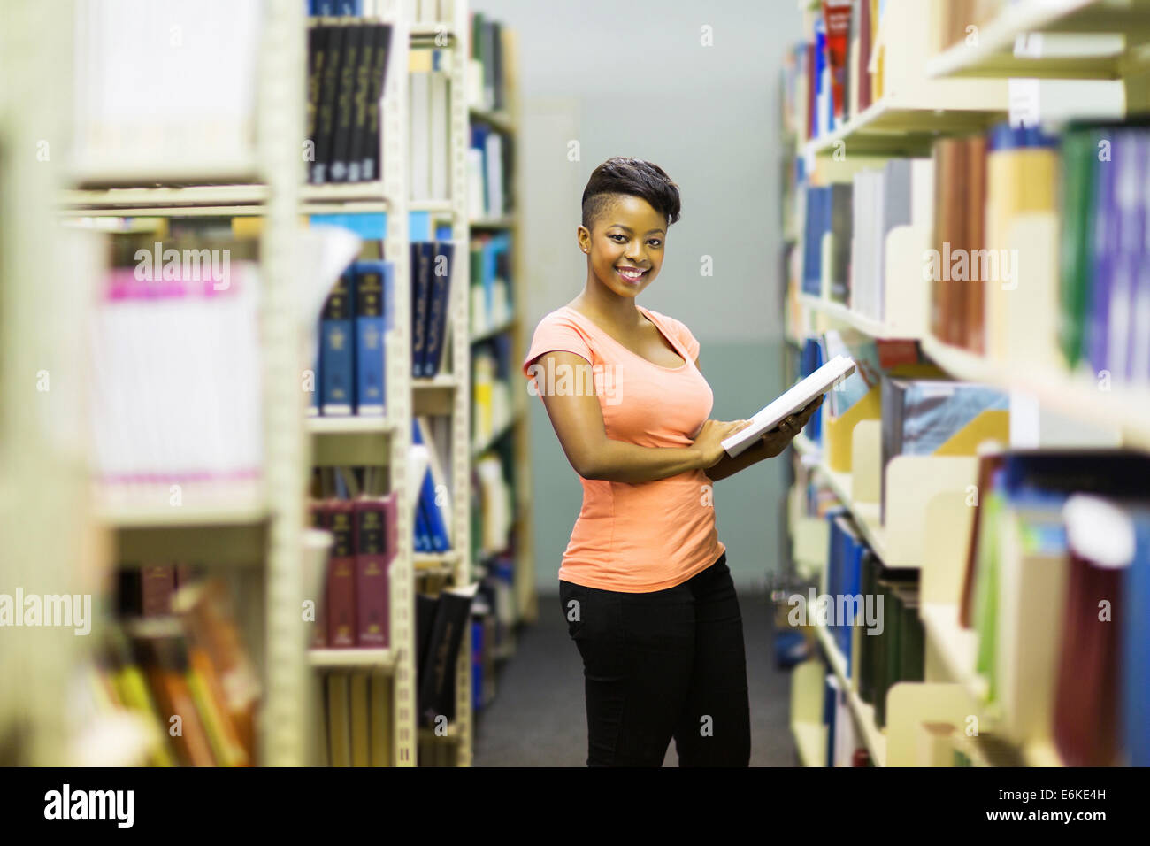 beautiful African college girl in library Stock Photo - Alamy