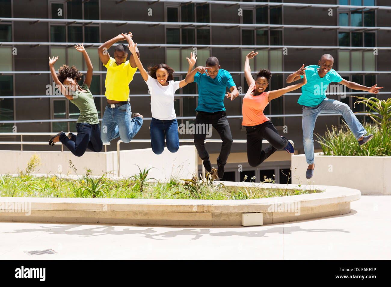 group of happy African college students jumping high Stock Photo