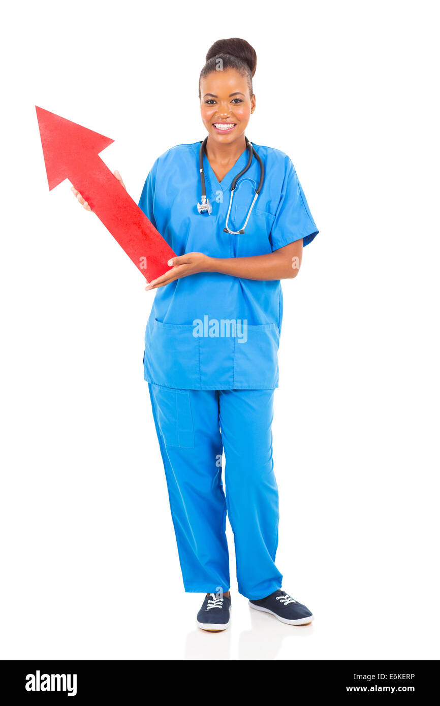 young African American nurse holding arrow sign pointing up Stock Photo ...