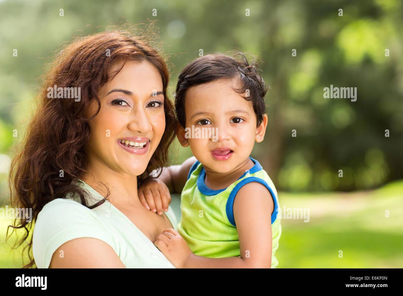 portrait of happy young Indian mother and baby boy outdoors Stock Photo