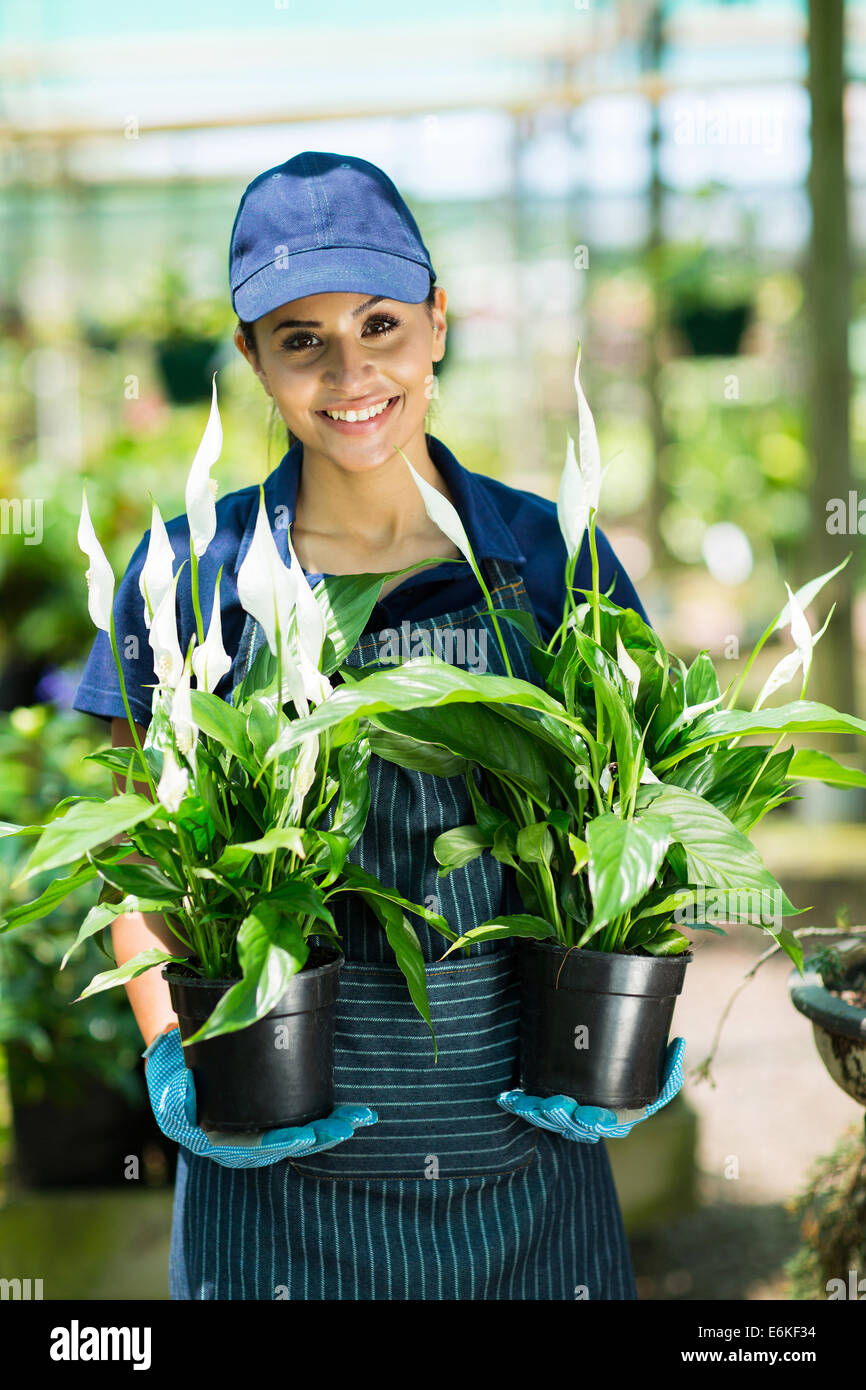 smiling female gardener holding two potted plants Stock Photo - Alamy