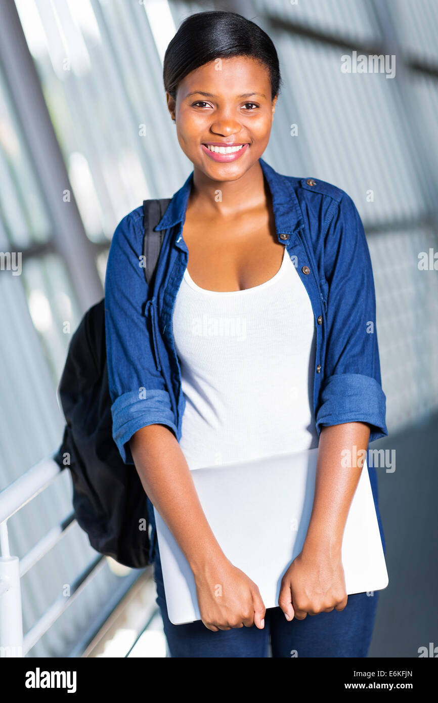 cheerful African American college student with laptop computer on campus Stock Photo