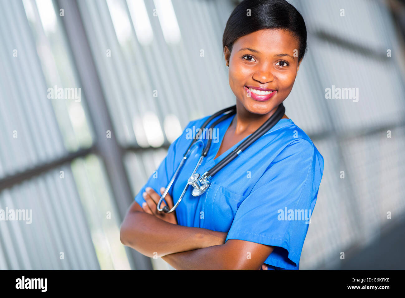 pretty young African American doctor with arms crossed Stock Photo