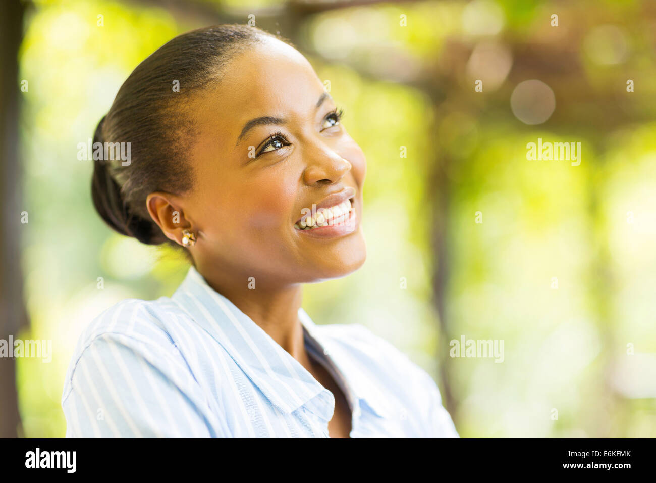 cute young African woman daydreaming Stock Photo - Alamy