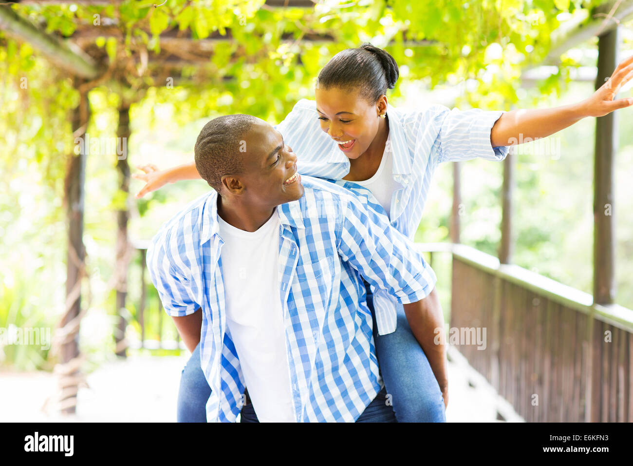 cheerful African American couple piggyback outdoors Stock Photo - Alamy