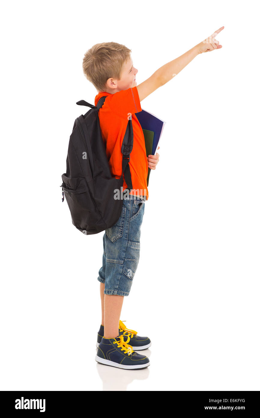 primary schoolboy pointing at empty copyspace isolated on white Stock Photo