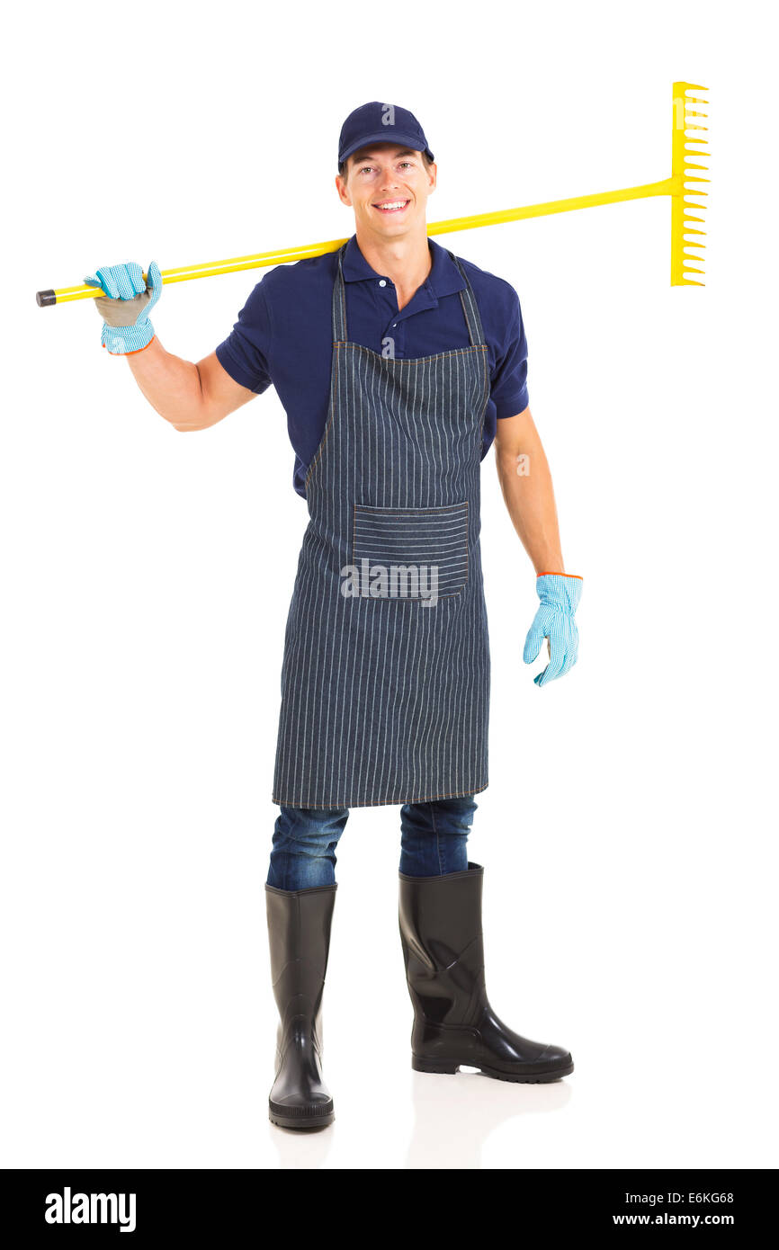 gardener carrying a rake over his shoulder on white background Stock Photo